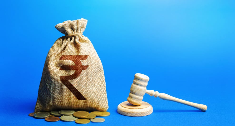 Indian rupee money bag and judge's gavel. Litigation, dispute resolution, conflict of interest settlement. Justice. Lawyer services. Awarding moral financial compensation. Protection rights.